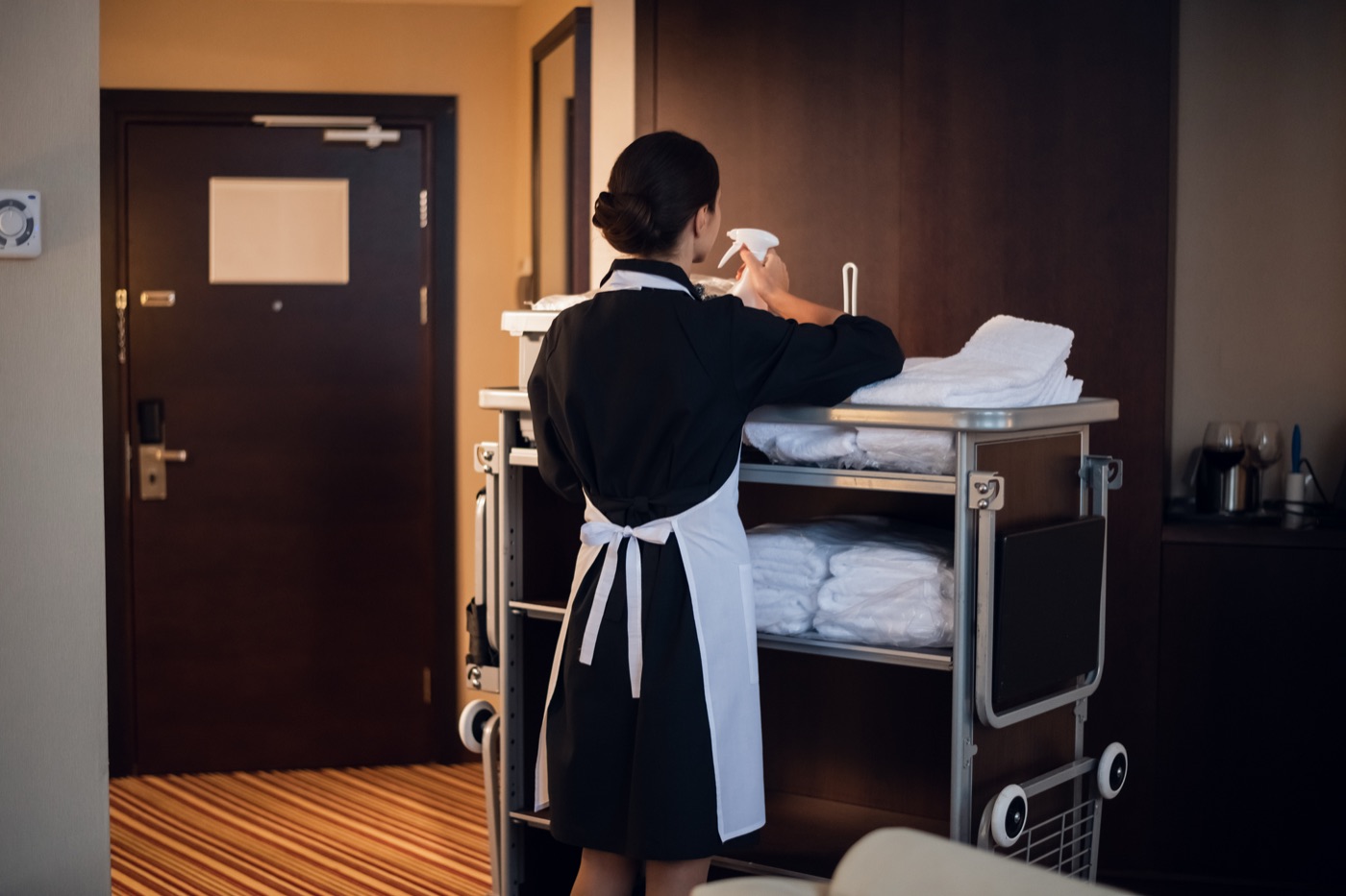 hotel housekeeper cleaning hotel room